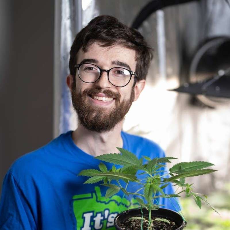 Tanner growing cannabis plant.